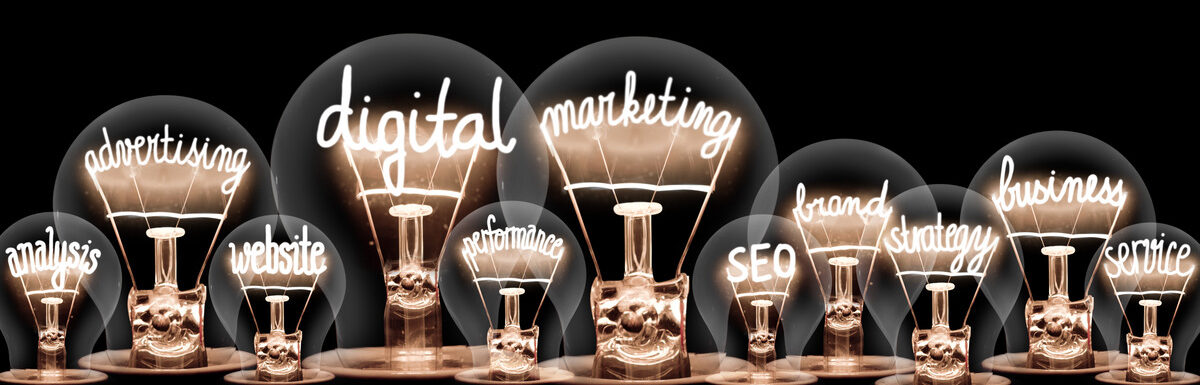 A line of large and small lightbulbs with marketing related terms inside of them, such as “SEO” and “strategy.”