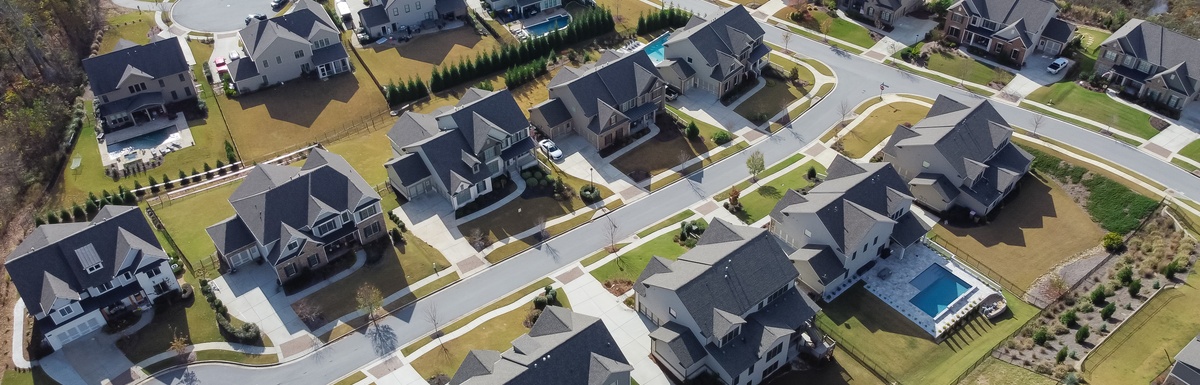 An aerial view of a residential neighborhood. There are two cul-de-sacs and all the houses are two stories.