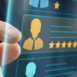 A businessman's hand selecting a candidate from multiple icons with rankings that represent different people.